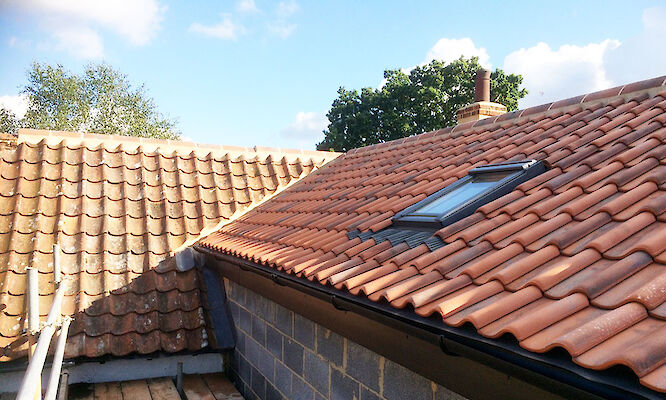 Roofer in Norfolk completing tiled roof repairs